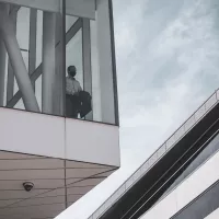 person looking out of the window of a building