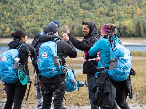group of people on a hike and giving high fives