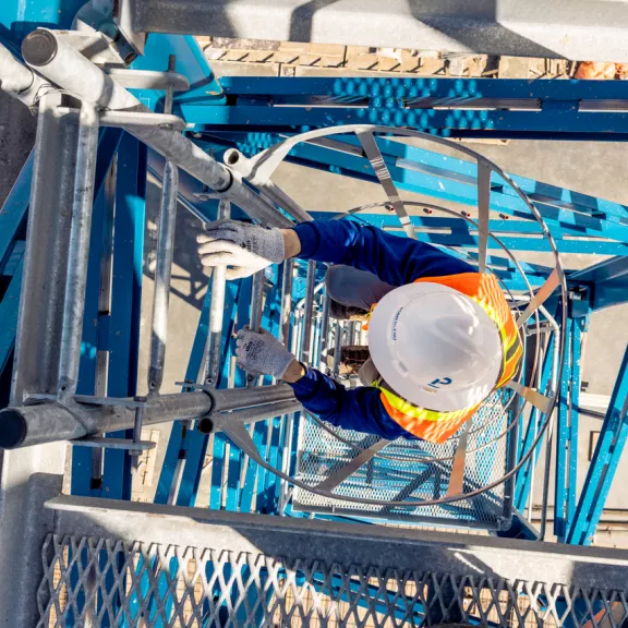 worker climbing down ladder