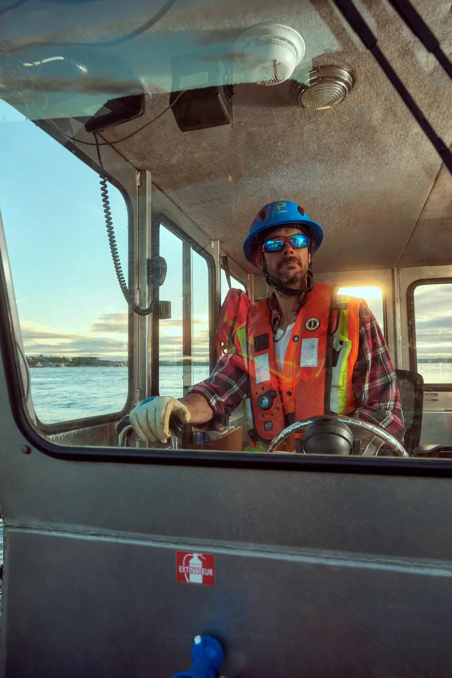 Pomerleau's workers on the construction site of the Port of Trois-Rivieres in Quebec, using special equipment for port infrastructure