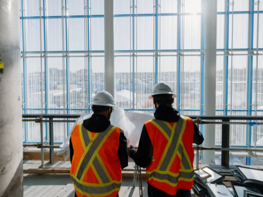 Workers from Pomerleau on a commercial construction site.