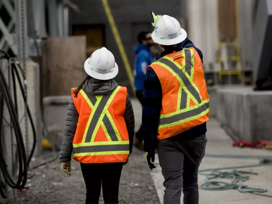 Pomerleau construction workers on the construction site of the Biomethanation Centre for Organic Matter in Quebec City wearing protective gear for safety